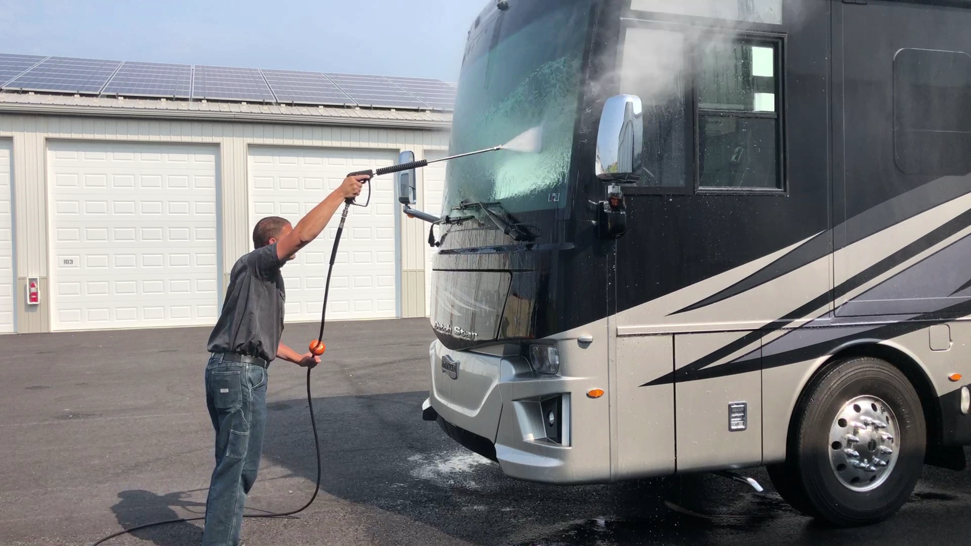 Heritage RV Wash Club member using the pressure washer on a motorhome windshield